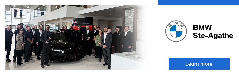 BMW Sainte-Agathe team gathered in the showroom with a luxury vehicle