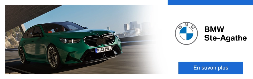 Nouvelle BMW M5 Touring 2025 en conduite sur route, en vedette chez BMW Ste-Agathe avec bouton En savoir plus.